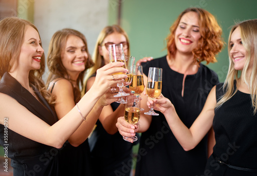Party and celebration. Group of  happy smiling young women drinking champagne having fun together.