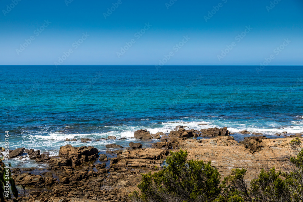 Traveling along the Great Ocean Road in New South Wales, Australia, visiting a beach next to the Seven Miles Beach National Park at a sunny day in summer. Traveling along the Great Ocean Road in New South Wales, Australia, visiting a beach next to the Seven Miles Beach National Park at a sunny day in summer.