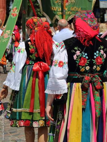 Local people from Lowicz region in traditional folk costume while walk in Corpus Christi procession