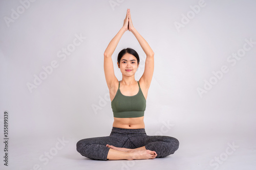 doing yoga or pilates exercise. Sitting in Warrior one pose, Virabhadrasana
