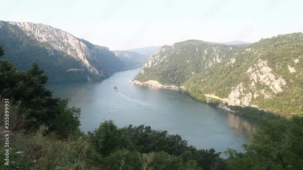 Danube river summer landscape. The cruiser ship passes through the part of the gorge on the Danube between Serbia and Romania, also known as the Iron Gate. Danube river summer landscape. The cruiser ship passes through the part of the gorge on the Danube between Serbia and Romania, also known as the Iron Gate.