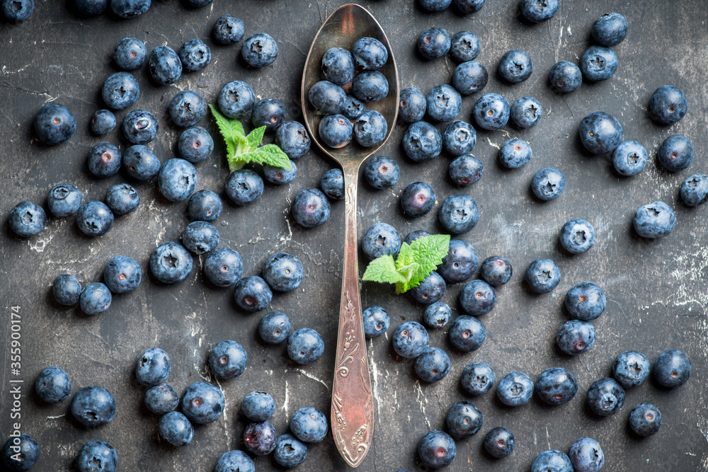 Freshly harvested blueberries on the spoon. Selective focus. Shallow depth of field. Freshly harvested blueberries on the spoon. Selective focus. Shallow depth of field.
