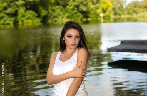 Gorgeous young woman with stylish makeup. Pretty girl closeup portrait on river background