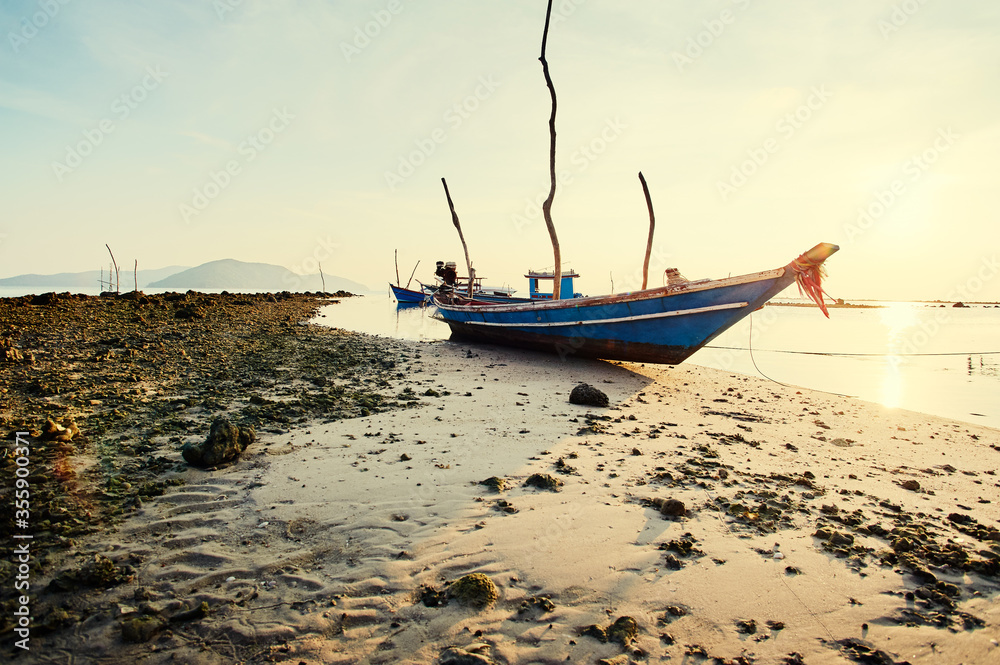 Fototapeta premium Travel by Thailand. Landscape with traditional longtail fishing boat on the sea beach.