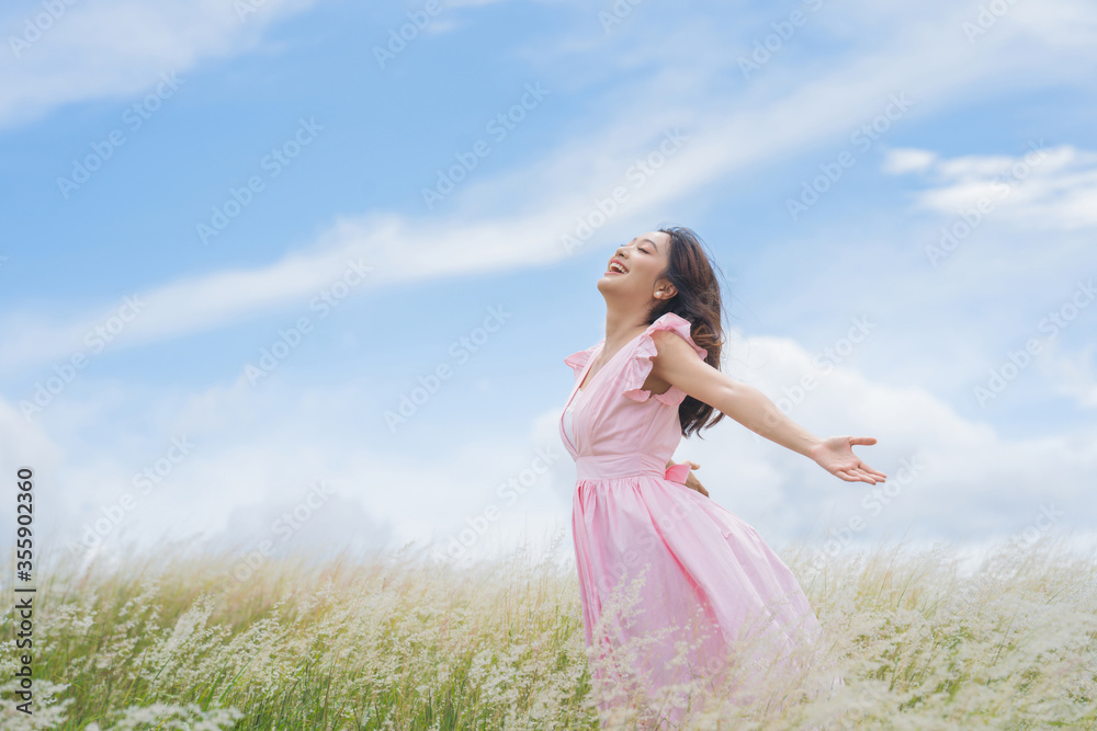 Beautiful asian woman She is having freedom at the meadow. She is happy. Beautiful asian woman She is having freedom at the meadow. She is happy.