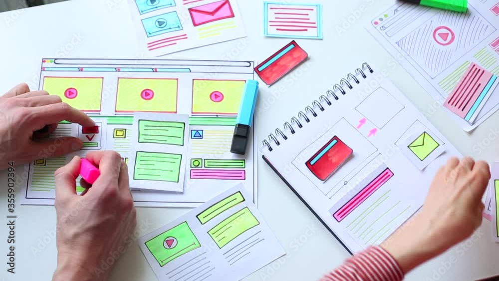 A website designer is working on an application interface. The developer draws sketches of user applications for smartphones.