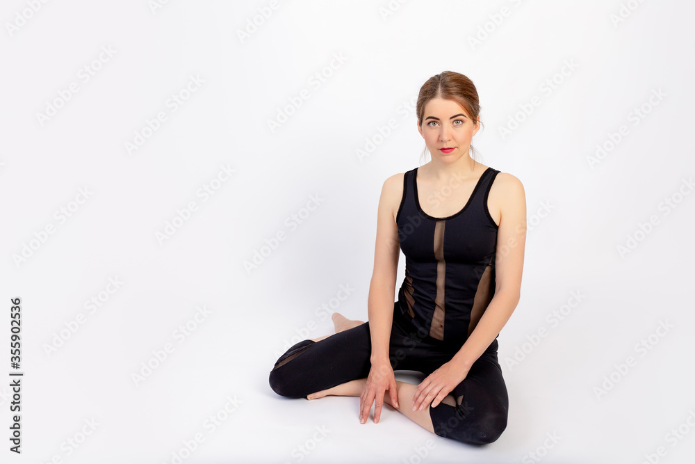 athletic girls sitting after a sports workout on a white isolated background, space for text