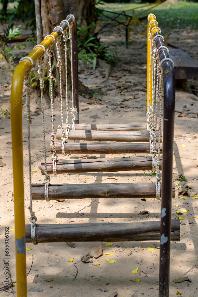 Fototapeta premium the rope and wood ladder at playground in Thailand.