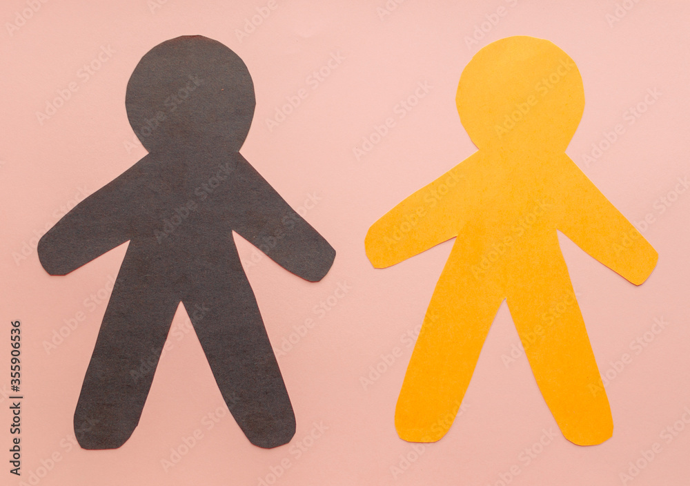 Flat lay black, yellow, white paper people holding hands on blue background, top view. Unity concept. Stop racism, black lives matter, social exclusion message, misunderstanding, denial of society. Flat lay black, yellow, white paper people holding hands on blue background, top view. Unity concept. Stop racism, black lives matter, social exclusion message, misunderstanding, denial of society.