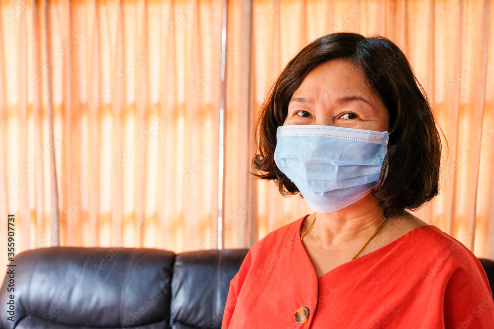Asian elder women wearing surgical face mask to protect, prevent from Coronavirus disease.New normal and Social distance concept during pandemic. Personal healthcare concept. With copy space. Asian elder women wearing surgical face mask to protect, prevent from Coronavirus disease.New normal and Social distance concept during pandemic. Personal healthcare concept. With copy space.