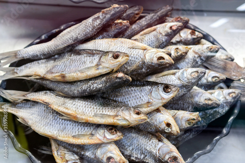 dried fish Rudd. lies on the counter in the market, salty snacks. roach