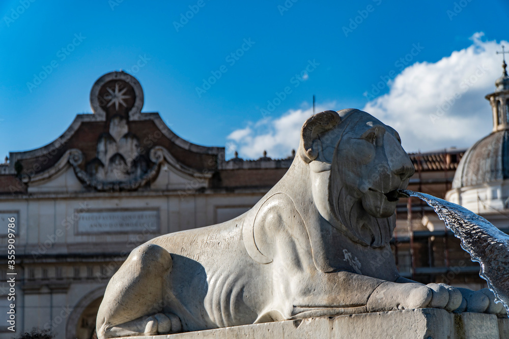 Lion fountain in Piazza del Popolo with church dome Rome, Italy