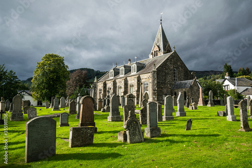 Old church of Moulin graveyard near Pitlochry, Scotland with storm clouds over the surrounding hills. photo