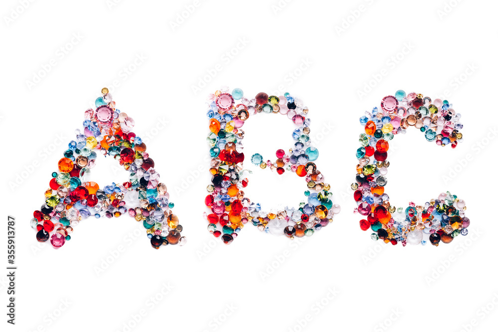 Letters A, B, C made from beautiful glass bright gems or crystals on isolated white background