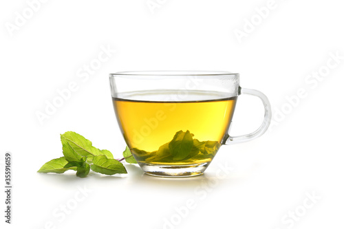 herbal tea made from fresh peppermint leaves in a glass cup isolated on a white background