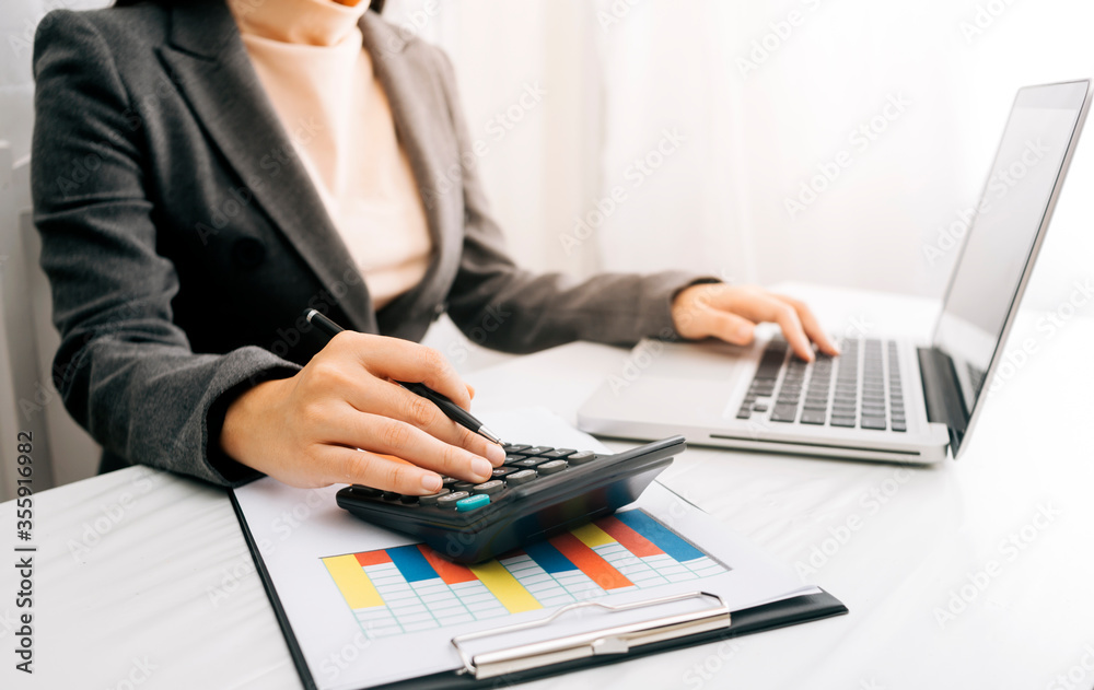 business documents on office table with calculate and digital tablet and graph financial and man working business documents on office table with calculate and digital tablet and graph financial and man working