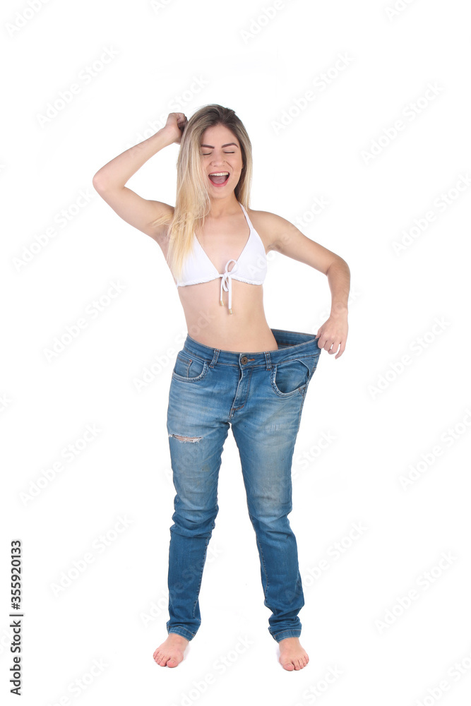 Weight loss background. Proud beautiful fitness woman measuring her body with pants and measuring tape. Weight loss background. Proud beautiful fitness woman measuring her body with pants and measuring tape.