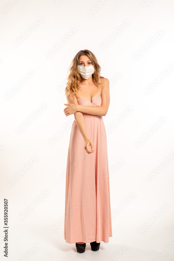 Woman wearing surgical mask on a white background