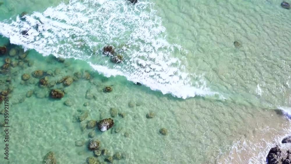 Aerial Drone Above Clear Blue Shallow Ocean Water Waves Splashing Over Rocks At Beach In Australia Aerial Drone Above Clear Blue Shallow Ocean Water Waves Splashing Over Rocks At Beach In Australia
