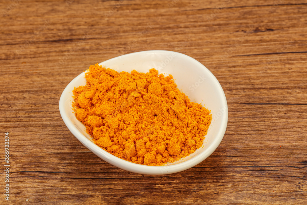Tumeric powder in the bowl Tumeric powder in the bowl