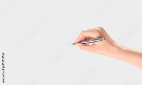Hand and pen writing on a white background