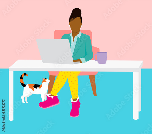 Work from home concept - woman in home office working on laptop looking professional on top and casual pajamas below