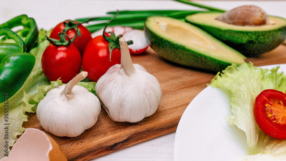 Fresh garden vegetables on cutting board - ingredients for a sal