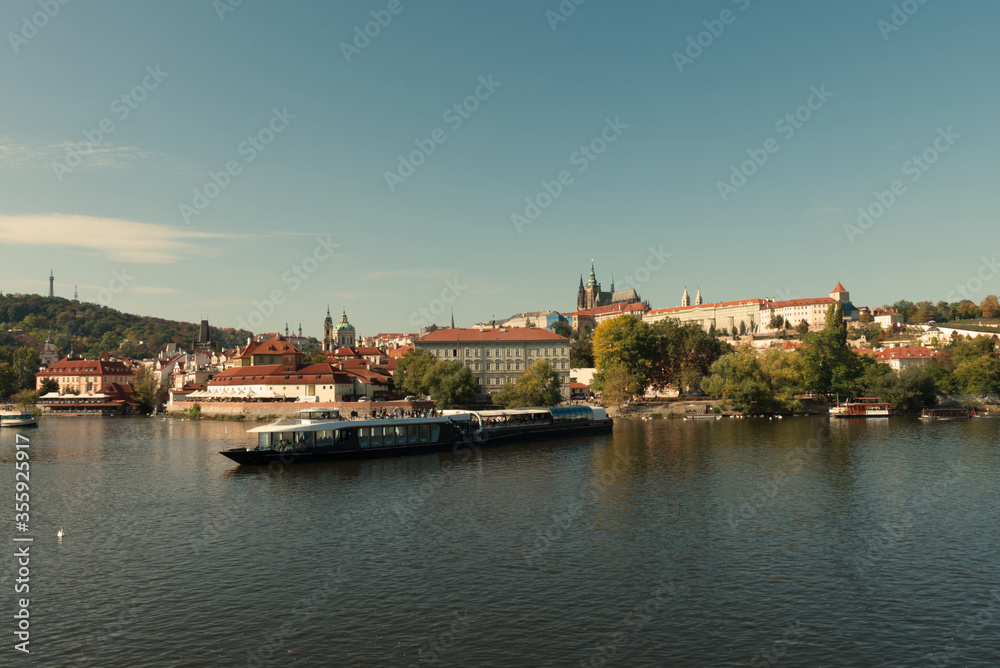 Pleasure boat on the Vltava pier in the fall. View of Prague.