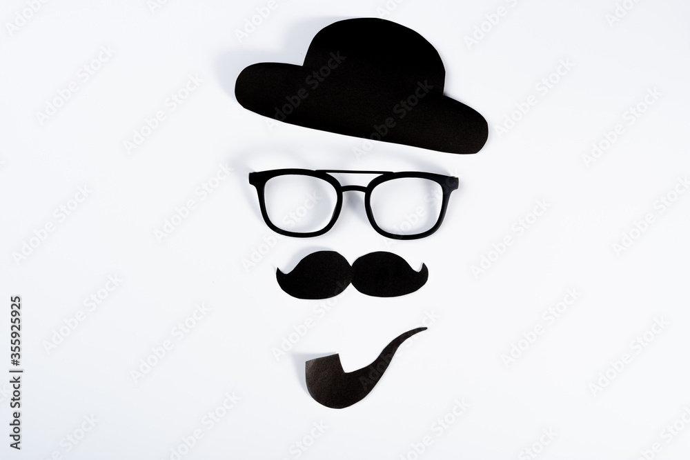 Happy Father Day background concept with paper cut of hat, glasses, black mustache and smoking pipe on white background with copy space for text. Happy Father Day background concept with paper cut of hat, glasses, black mustache and smoking pipe on white background with copy space for text.