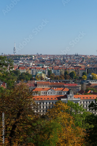View of Prague through the branches of autumn trees.