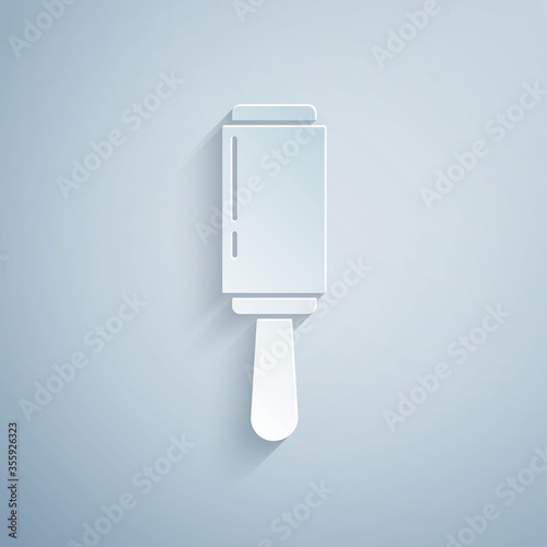 Paper cut Adhesive roller for cleaning clothes icon isolated on grey background. Getting rid of debris, dust, hair, fluff, pet wool. Paper art style. Vector Illustration