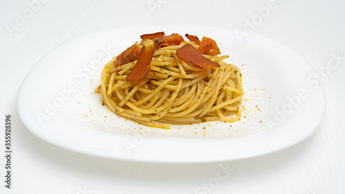 spaghetti with mullet fish and tomato on the plate