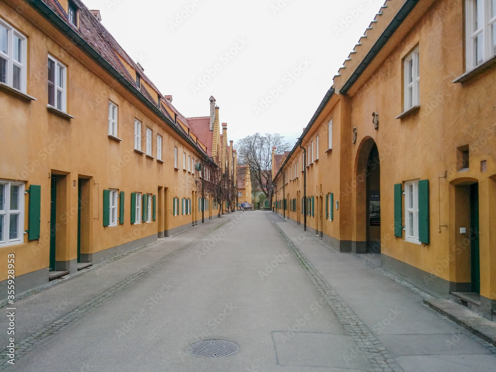 Augsburg, Germany - April 5, 2017: The Fuggerei, the world's oldest social housing complex Augsburg, Germany - April 5, 2017: The Fuggerei, the world's oldest social housing complex