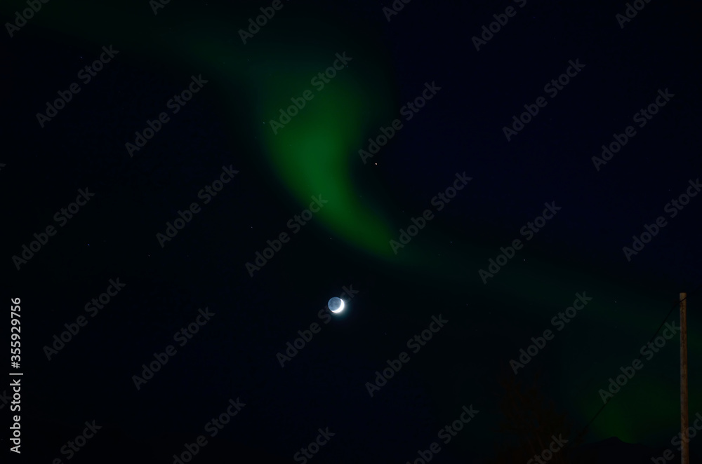 majestic aurora borealis dancing around full moon in winter night
