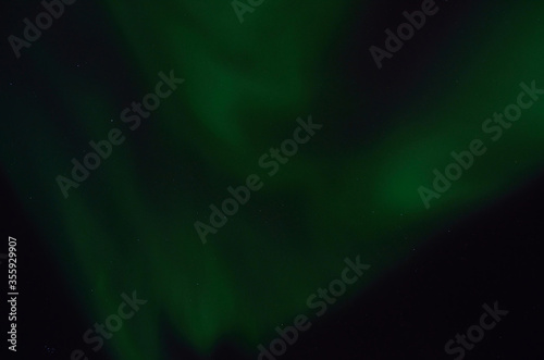 majestic aurora borealis on dark star filled night sky background