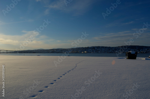 tromsoe city island in snowy winter sun in early morning