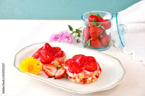 Homemade tasty mini Strawberry and Yogurt cream sponge cake. two small Delicate and delicious biscuit cakes with cream and strawberries. Beautiful birthday cake on table
