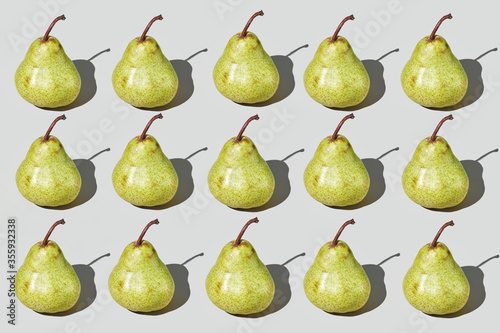 Colourful pattern of pears on grey background. View from top.
