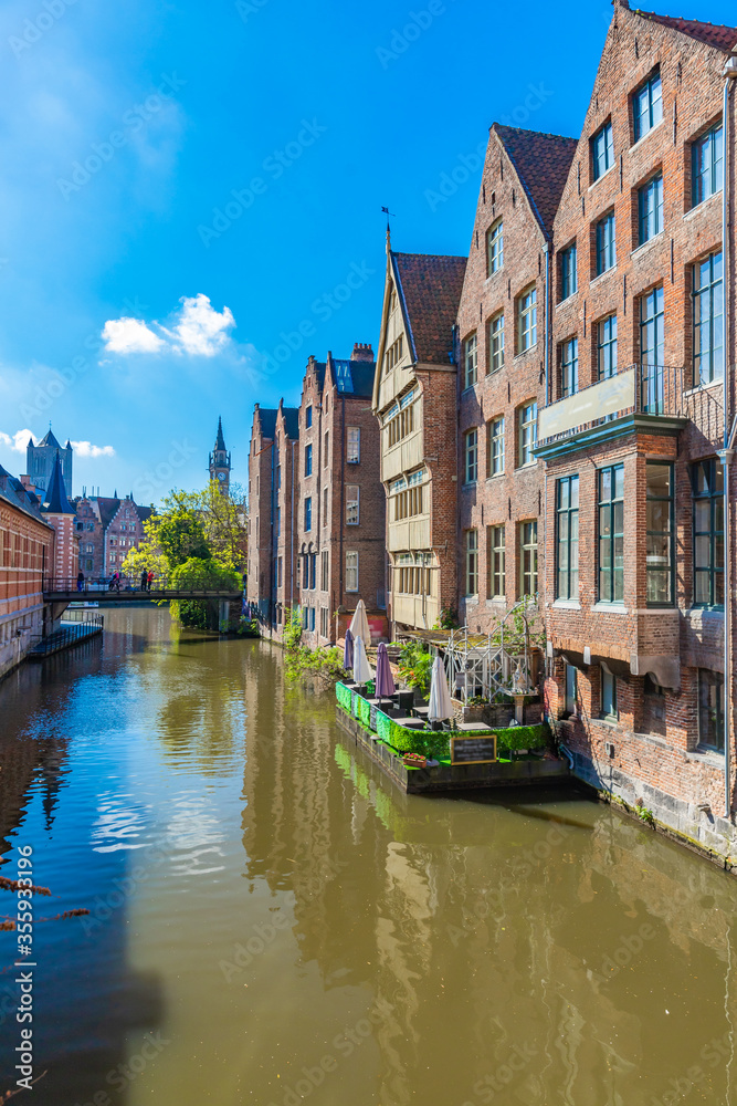 Red brick houses and river restaurant in Ghent, Belgium