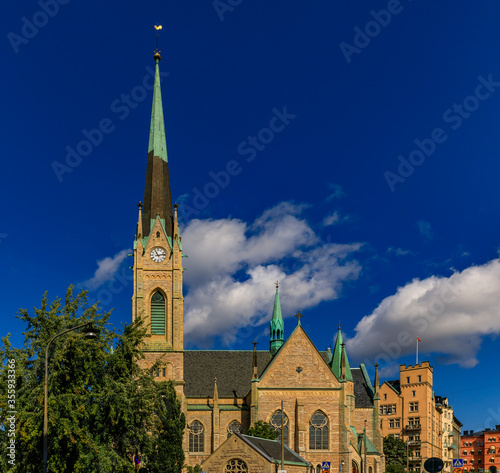 Oscarskyrkan or Oscar's Church in the Ostermalm district with traditional buildings in the background, Stockholm, Sweden photo