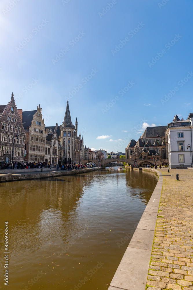 Saint Michael bridge and Saint Bavo Cathedral view from river Leie embankment in Ghent, Belgium
