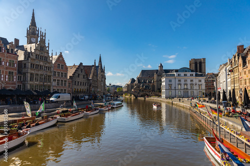 Saint Michael bridge and Saint Bavo Cathedral view from river Leie embankment in Ghent, Belgium