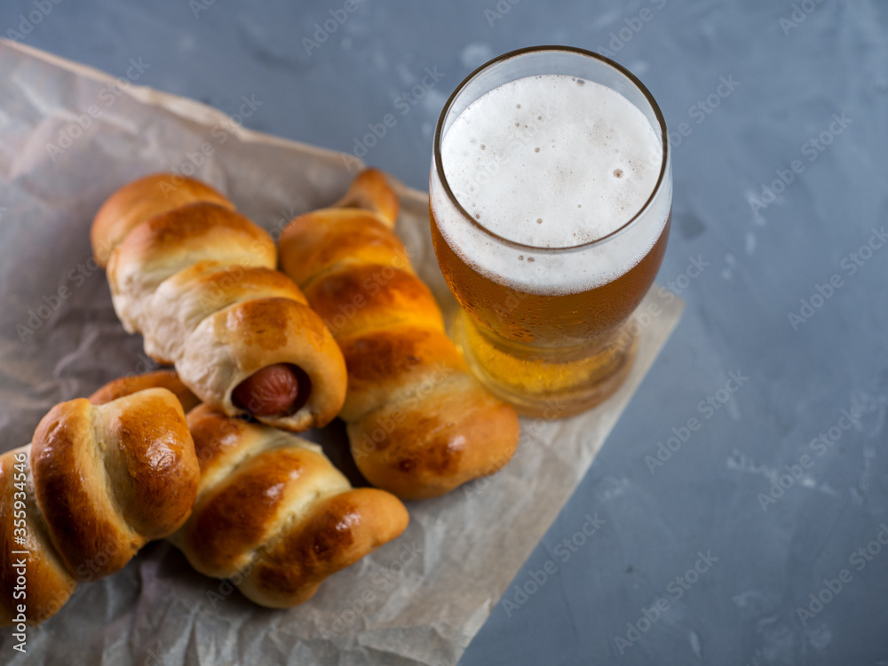 A glass of beer top view and homemade sausages in the dough. Beer and snacks A glass of beer top view and homemade sausages in the dough. Beer and snacks