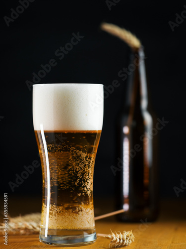 Wallpaper Mural Cold Light beer lager in a glass on a dark table close up Torontodigital.ca