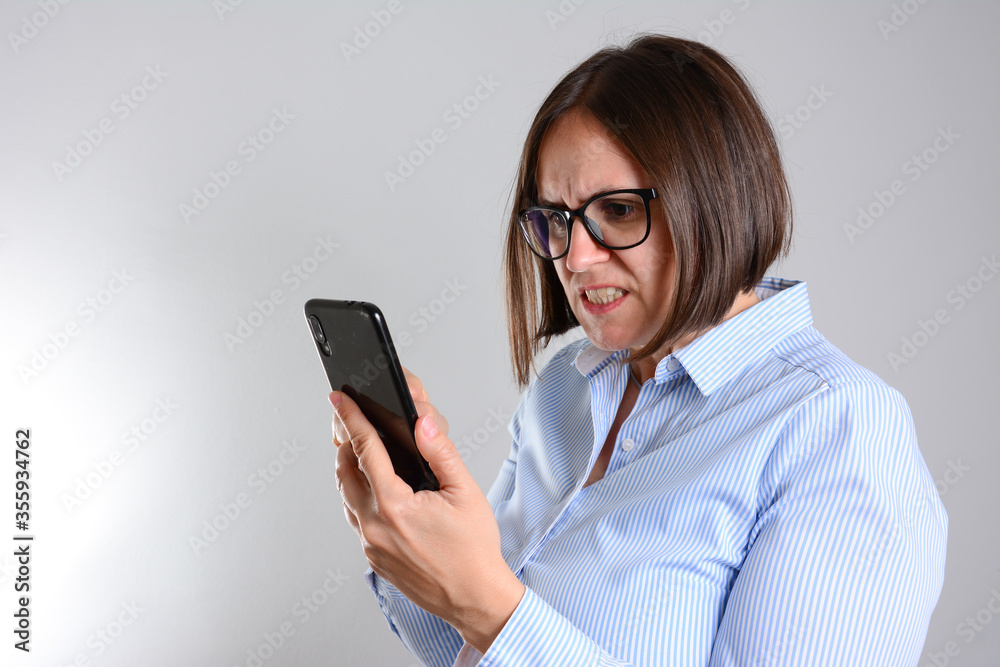 Stressful businesswoman talking on the mobile phone. angry young woman disappointed with the news from her work and screaming on the phone