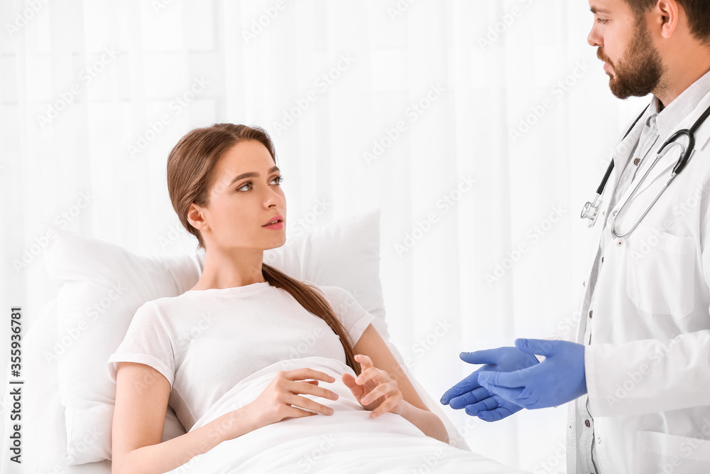 Male doctor working with patient in hospital room Male doctor working with patient in hospital room