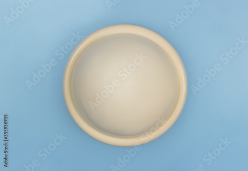 a diaphragm, a non-hormonal, barrier method of female contraception inserted in the vagina before sex, on a blue background