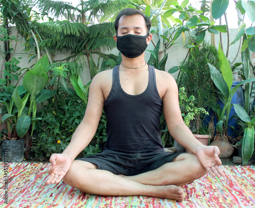 Man practicing meditation Yoga during Covid-19