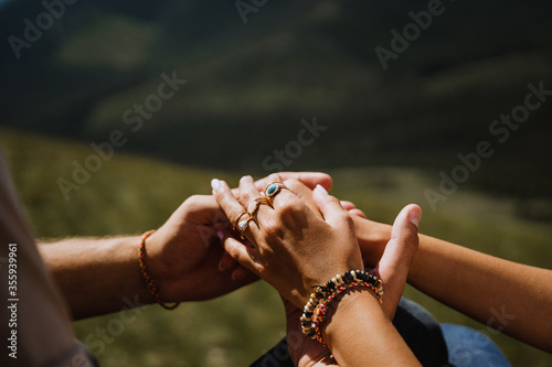 man and woman holding each other's hands, close-up, in nature, outdoors, hugs, tenderness