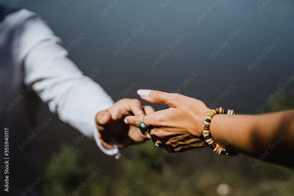 man and woman holding each other's hands, close-up, in nature, outdoors, hugs, tenderness